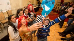 Singer Tina Tores poses for a selfie with attendees of the Foundation for Autism Acceptance Worldwide's annual fundraiser on December 11, 2016 in Groton, Connecticut.