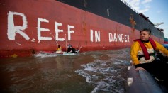 Activists paint the message 'Reef in Danger' on the side of coal ship Chou San on March 7, 2012 in Gladstone, Australia. 