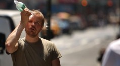  A man tries to cool himself with a bottle of water during the first heat wave of the year June 9, 2008 in New York City.