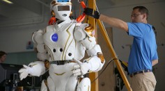 Court Edmondson works on the team NASA robot during the DARPA Robotics Challenge 
