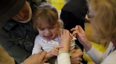 A young girl is given an annoculation at a medical centre set up in Cockermouth Methodist Church on November 25, 2009 in Cockermouth, England.