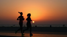 Runners jog along the recently refurbished Kite Beach is pictured on September 14, 2015 in Dubai, United Arab Emirates.