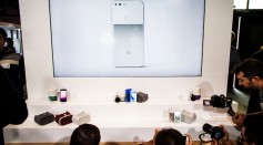 Members of the media photograph a display of Google's Pixel phone and other products during an event to introduce Google hardware products on October 4, 2016 in San Francisco, California.