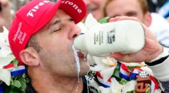 Tony Kanaan of Brazil takes a sip of milk in victory lane as he celebrates winning the IZOD IndyCar Series 