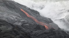 Lava flows into the ocean from Kilauea Volcano at Volcanoes National Park near Volcano, Hawaii on June 6, 2004. 