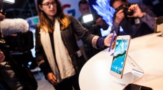 Members of the media examine Google's Pixel phone during an event to introduce Google hardware products on October 4, 2016 in San Francisco, California