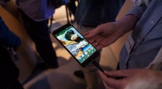 Members of the media examine Google's Pixel phone during an event to introduce Google hardware products on October 4, 2016 in San Francisco, California