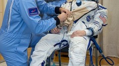 Soyuz MS-11 Anne McClain suits up in a Sokol space suit