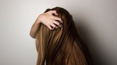 Girl covering her face with her hair