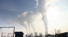 Smokestacks from factories introduce greenhouse gases like carbon dioxide into the atmosphere.