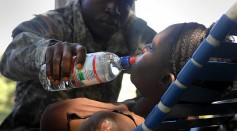 Army Soldier Aiding Earthquake Victim