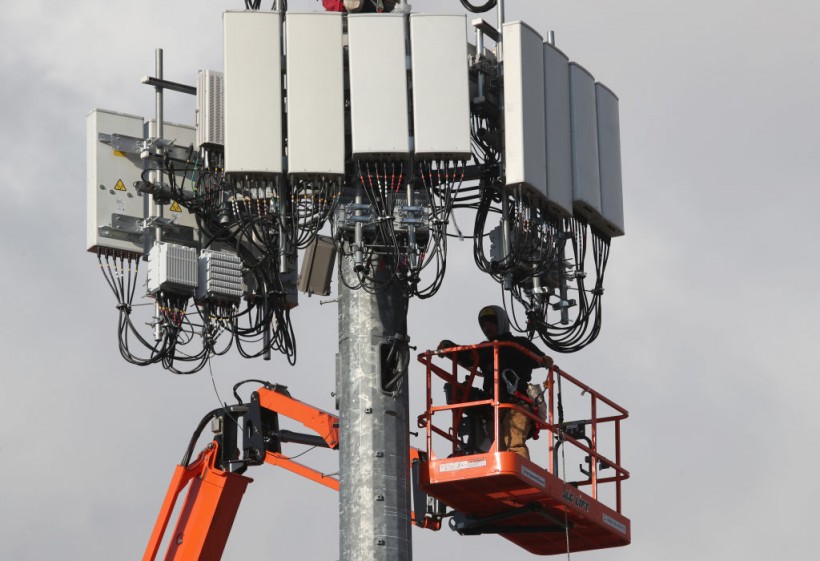 Science Times - Utility Workers Install 5G Equipment In Cellular Tower