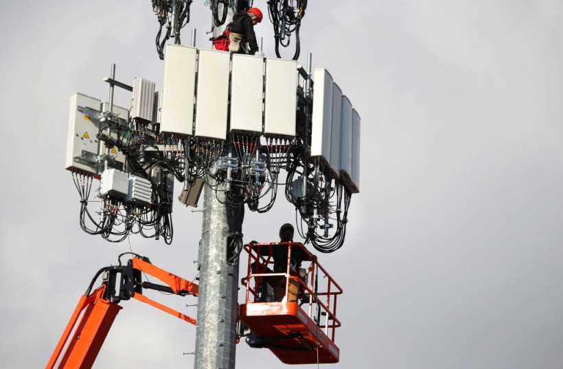 Utility Workers Install 5G Equipment In Cellular Tower