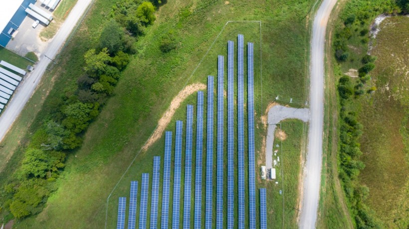 aerial-view-of-solar-panels-array-on-green-grass-2800845