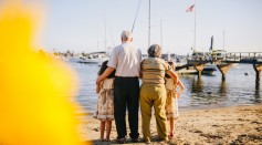 grandparents-with-their-granddaughters-standing-by-the-shore-5637770