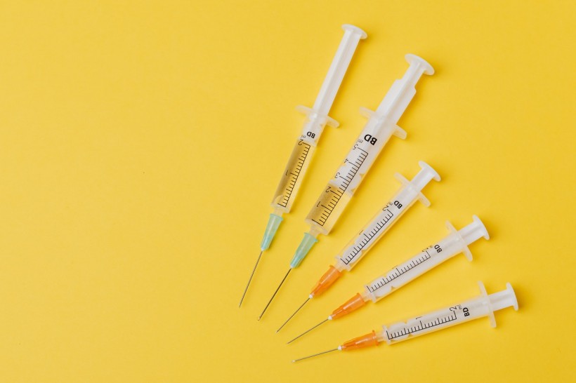 syringes-of-different-sizes-on-yellow-background-4210551