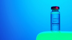 a-close-up-view-of-a-covid-19-vaccine-vial-on-blue-background-5878514