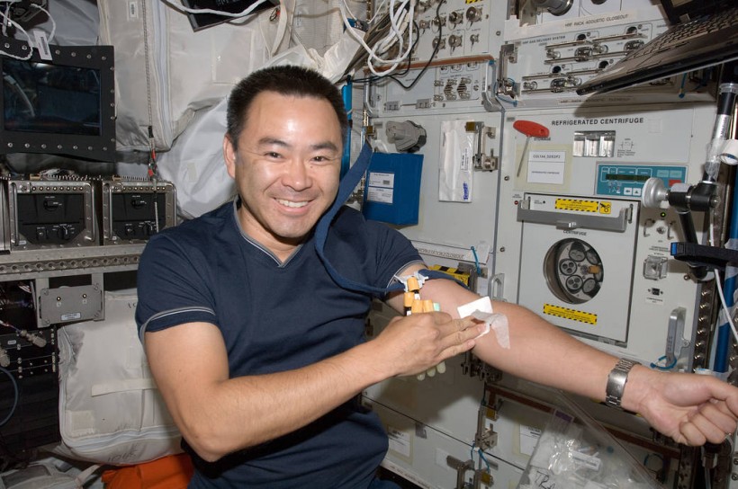Japanese Aerospace Exploration Agency astronaut Akihiko Hoshide poses for a photo after undergoing a generic blood draw in the European Laboratory/Columbus Orbital Facility (COF)