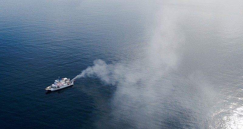A plume of seawater droplets rises up into the sky during a field trial in March 2021.