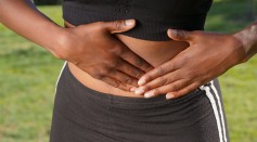 Close-Up Photo of Woman Touching her Abdomen