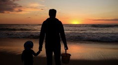 A dad and his daughter enjoy the last sunset of the year