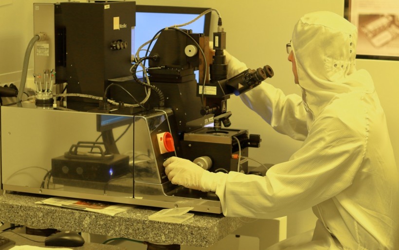 Engineer developing a new process in cleanroom