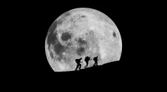 Silhouette Hikers Walking Against Moon At Night - stock photo