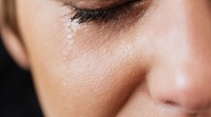 Lonely woman crying with closed eyes