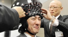 A man wears a brain-machine interface, e