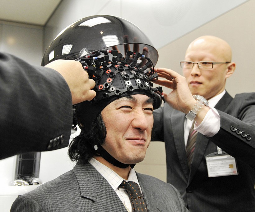 A man wears a brain-machine interface, e