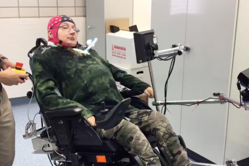 One of the participants, with a complete spasmodic tetraplegia sub C3 and needing assisted ventilation, during his training with the brain-controlled wheelchair.