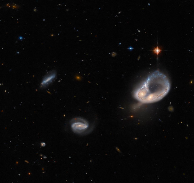  Hubble Space Telescope Captures Glowing Ring of Stars From a Pair of Entwined Galaxies