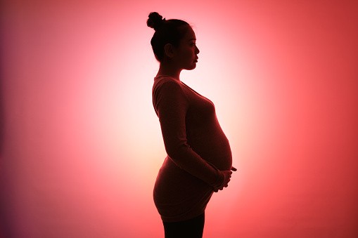 Portrait of a pregnant woman who is about to give birth. - stock photo