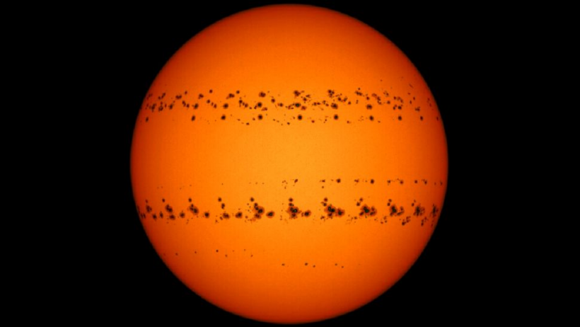 A time-lapse image of two major sunspot groups moving across the surface of the sun between Dec. 2 and Dec. 27, 2022, captured by Şenol Şanlı.