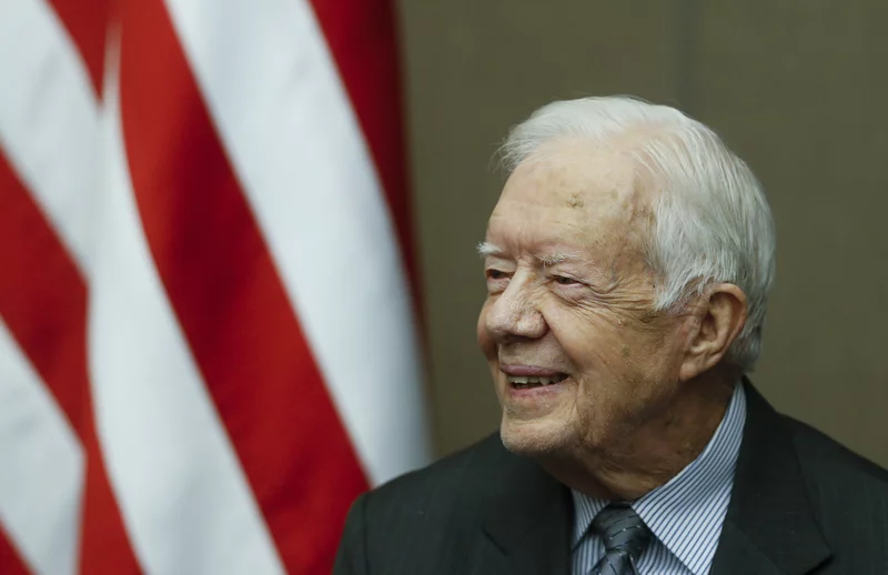 Former President Jimmy Carter smiles as he is awarded the Order of Manuel Amador Guerrero by Panamanian President Juan Carlos Varela during a ceremony at the Carter Center, Jan. 14, 2016, in Atlanta.