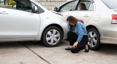 Women drivers sad after a car accident because not have car accident insurance
