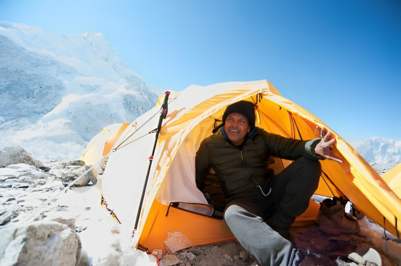 Man sitting in base camp tent, Everest, Khumbu glacier, Nepal