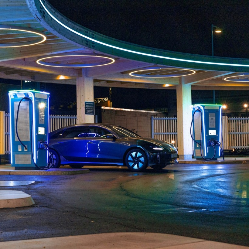 a blue car parked in front of a gas station