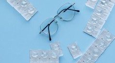 Black Framed Eyeglasses on Blue Table