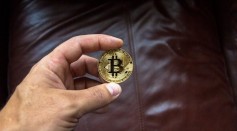 Round Gold-colored and Black Coin on Person's Hand