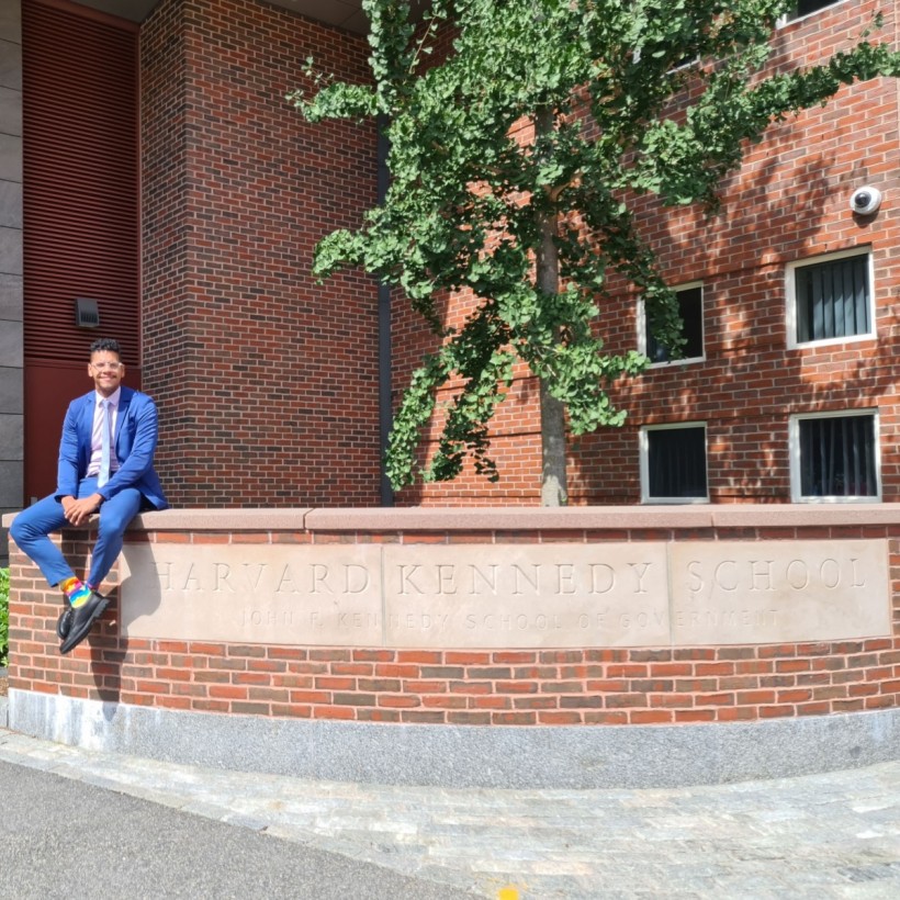 Posing in front of my alma mater the Harvard John F. Kennedy School of Government