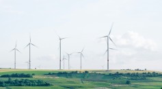 windmills surrounded by grass during daytime