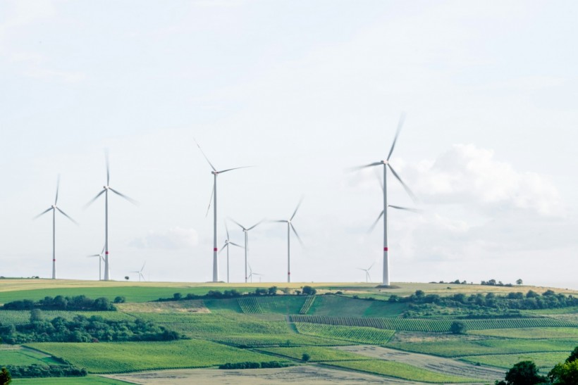 windmills surrounded by grass during daytime