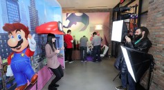 A guest poses for photos in the Super Mario Odyssey photo booth during a special press event in New York on Jan. 13, 2017.