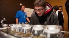 Tyler Williams of Blanchester, Ohio selects marijuana strains to purchase at the 3-D Denver Discrete Dispensary on January 1, 2014 in Denver, Colorado.