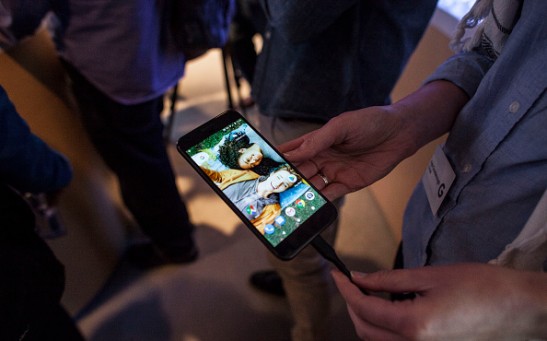 Members of the media examine Google's Pixel phone during an event to introduce Google hardware products on October 4, 2016 in San Francisco, California