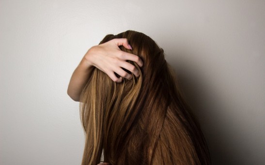 Girl covering her face with her hair