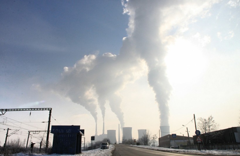 Smokestacks from factories introduce greenhouse gases like carbon dioxide into the atmosphere.