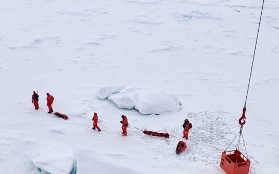 A scouting team surveys an ice floe for Polarstern