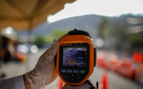 A Salvadoran doctor uses a thermal scanner to check people crossing the border as El Salvador's government has taken steadily stricter measures to prevent a possible spread of the coronavirus (COVID-19), in Ahuchapan, El Salvador March 13, 2020.
